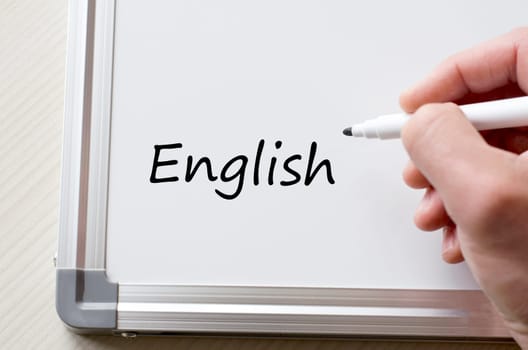 Human hand writing english on whiteboard