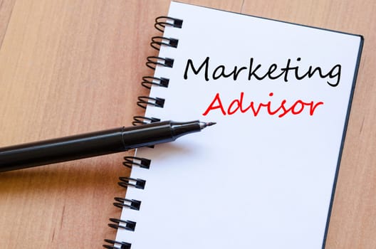 Marketing advisor text concept write on notebook