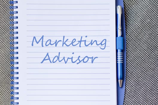 Marketing advisor text concept write on notebook