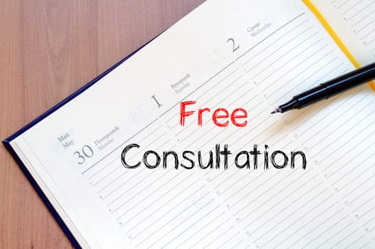 Free consultation text concept write on notebook