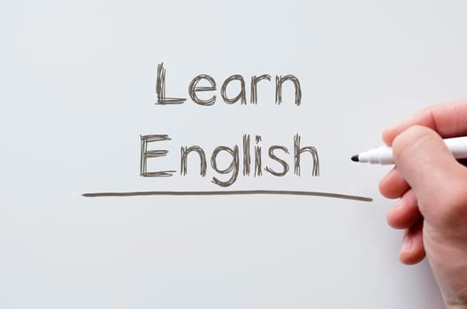 Human hand writing learn english on whiteboard