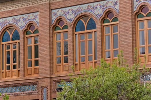 Tehran Province- IRAN-March 17  2016 Building Wooden Windows With Colorful Glasses and Decorated (hand painted) Terracotta Tiles Beside Urban Street.