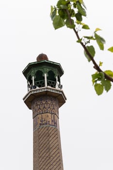 Iranian masque minaret isolated on white sky, Tehran Urban Area.