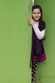 Portrait of a Beautiful Muslim Girl In Front of a Doorway