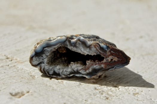 Druse Geode Agate Stone on White Wall in Sunlight