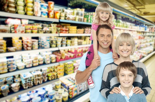 Image of young family grocery shopping in supermarket