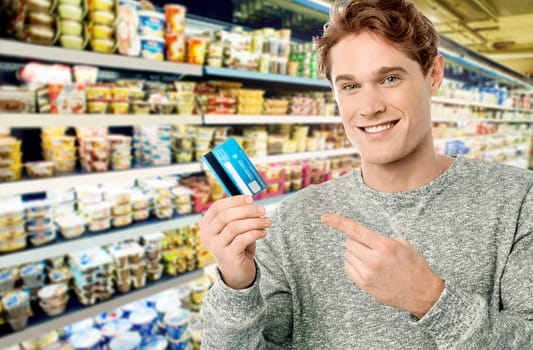 Man ready to buy household items in supermarket