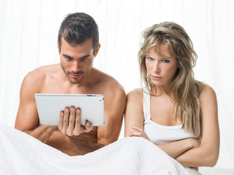 angry woman while his partner is watching a tablet