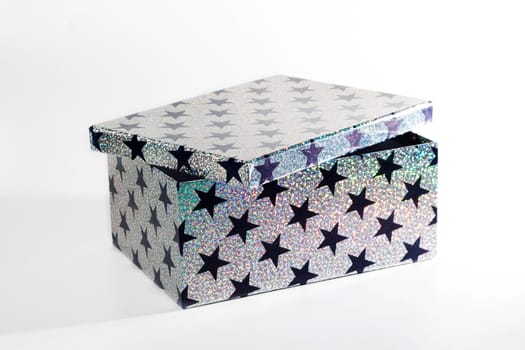 Giftbox with glitters and stars, isolated on white background