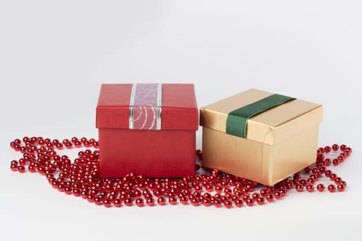 Two presents, red and gold, with ribbons, isolated