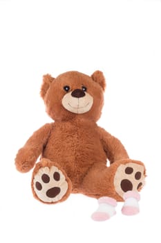 Teddy bear with pink socks, isolated on white background