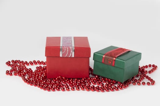 Two presents, red and green, with ribbons, isolated on white background