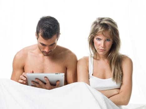 angry woman while his partner is watching a tablet
