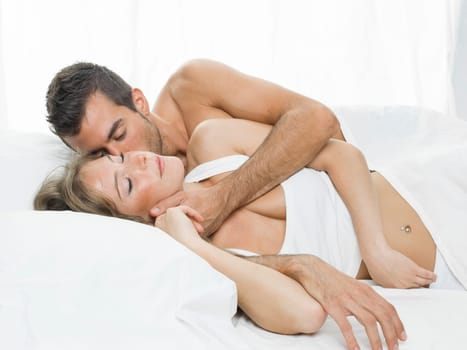 attractive woman and man together lying on the bed