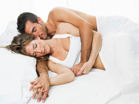 attractive woman and man together lying on the bed