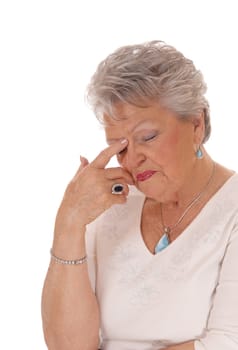 A closeup image of a very sad looking senior citizen woman in her seventies .with short grey hair isolated for white background..