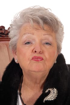 Lovely elderly woman giving a kiss in a closeup portrait image, with gray.white hair, isolated for white background..