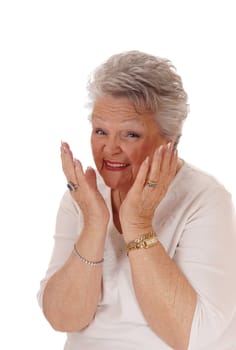 A gray haired senior citizen woman with her hands on her face,.smiling and is very happy, isolated for white background..