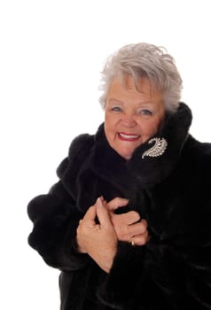 A lovely senior woman in a black fur coat laughing with her mouth open,.isolated for white background. .