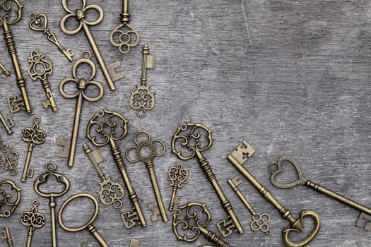 antique rusty key on grunge wooden background
