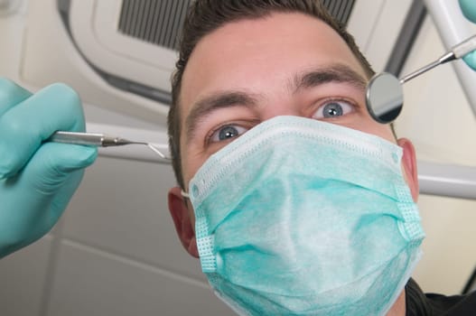 Picture of the dentist, as seen from the patient's point of view, lying in the chair