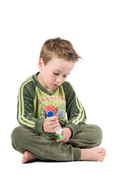 Studiopicture of a child who is going to brush his teeth, isolated on white.