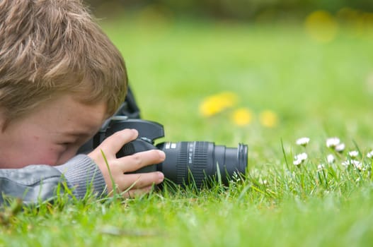 Young boy, nine years old, already practicing with an SLR shooting pictures of nature.