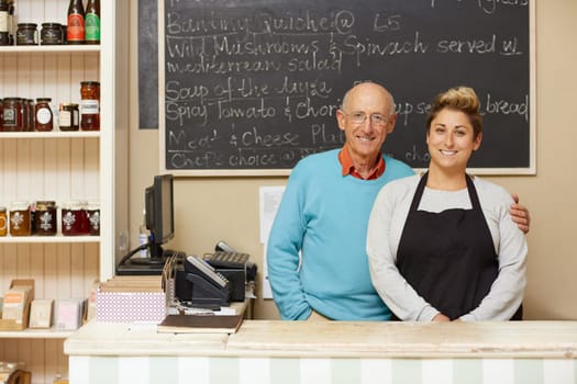 Two deli business owners behind the counter