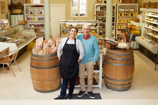 A father and daugther standing together in their deli