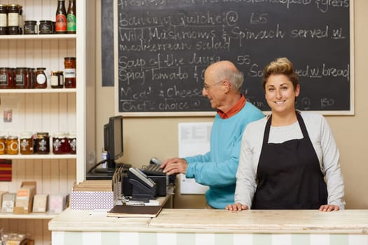 Two small business owners behind the deli counter