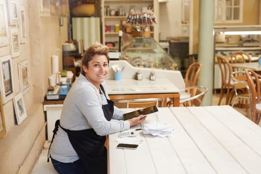 A female deli owner doing her taxes in her shop