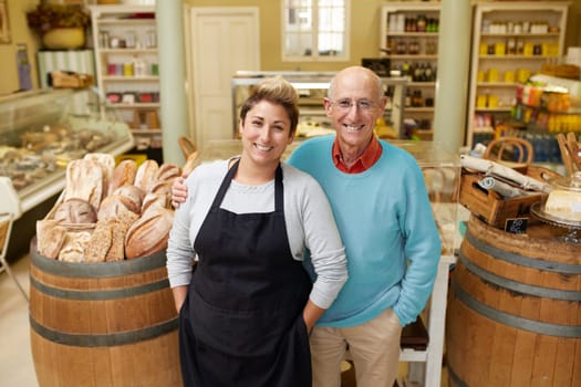 A father and daugther standing together in their deli