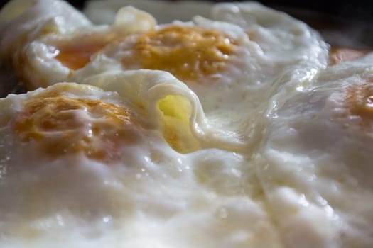 Closeup of fried eggs on a plate.