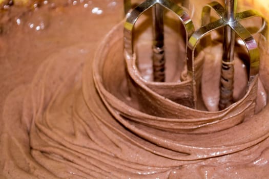 Mixing chocolite for cake with electric mixer