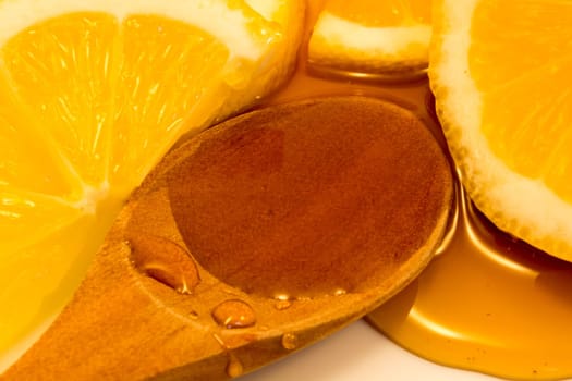 Wooden spoon with honey and sliced lemon