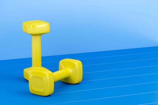 Two yellow dumbbells on shiny blue floor