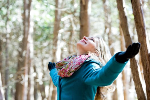 blond casual woman happy outdoors in the woods