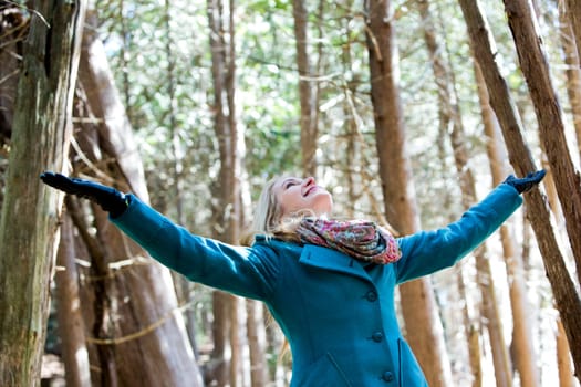 blond casual woman happy outdoors in the woods