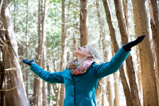 blond casual woman happy outdoors in the woods