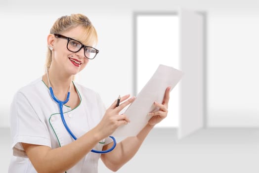 a nice female doctor writing her diagnosis in the hospital