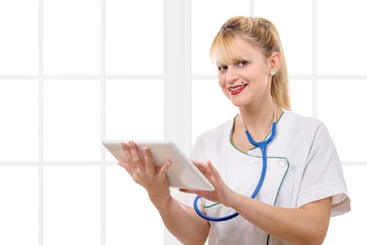 a beautiful nurse holding and using a digital tablet