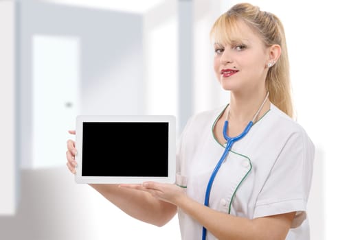 a young cheerful woman doctor is showing her blank tablet