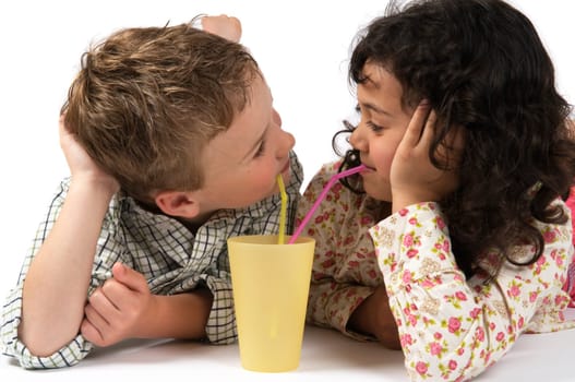 Boy and a girl drinking together with a straw.