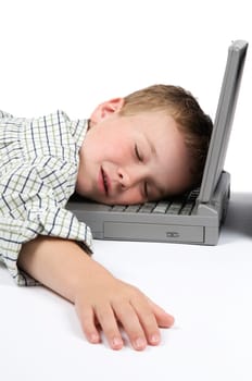 This boy has had too much schoolwork and has fallen asleep on his laptop.