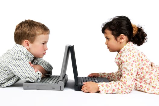 Two kids working on their laptop. Something made them angry...