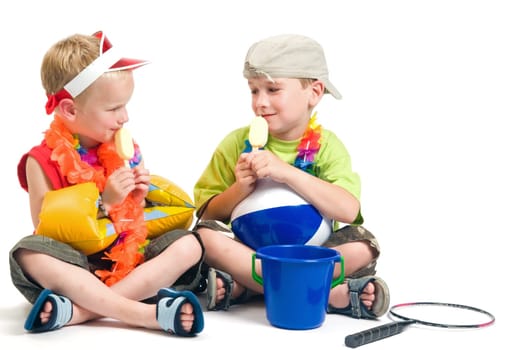 Two boys ready to go on vacation, enjoying their first icecream.