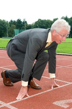 Businessman is ready for the start of his run.