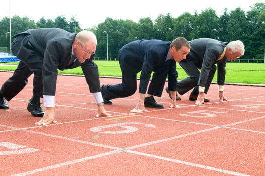 Group of businessmen are ready for the start of the run.