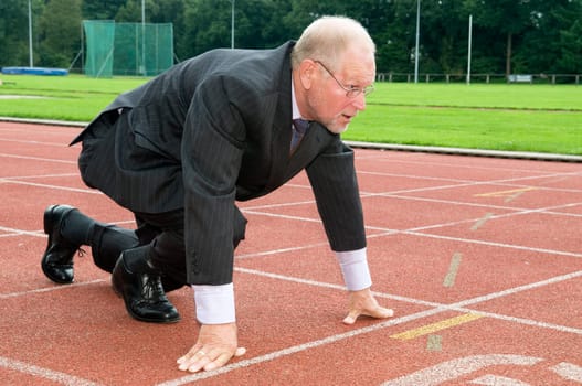 Businessman is ready for the start of his run.