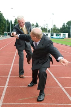 Two businessmen working as a team during a run.